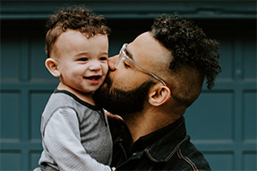 Blog post - Understanding anxiety patterns from generation to generation Man holding child | Unsplash